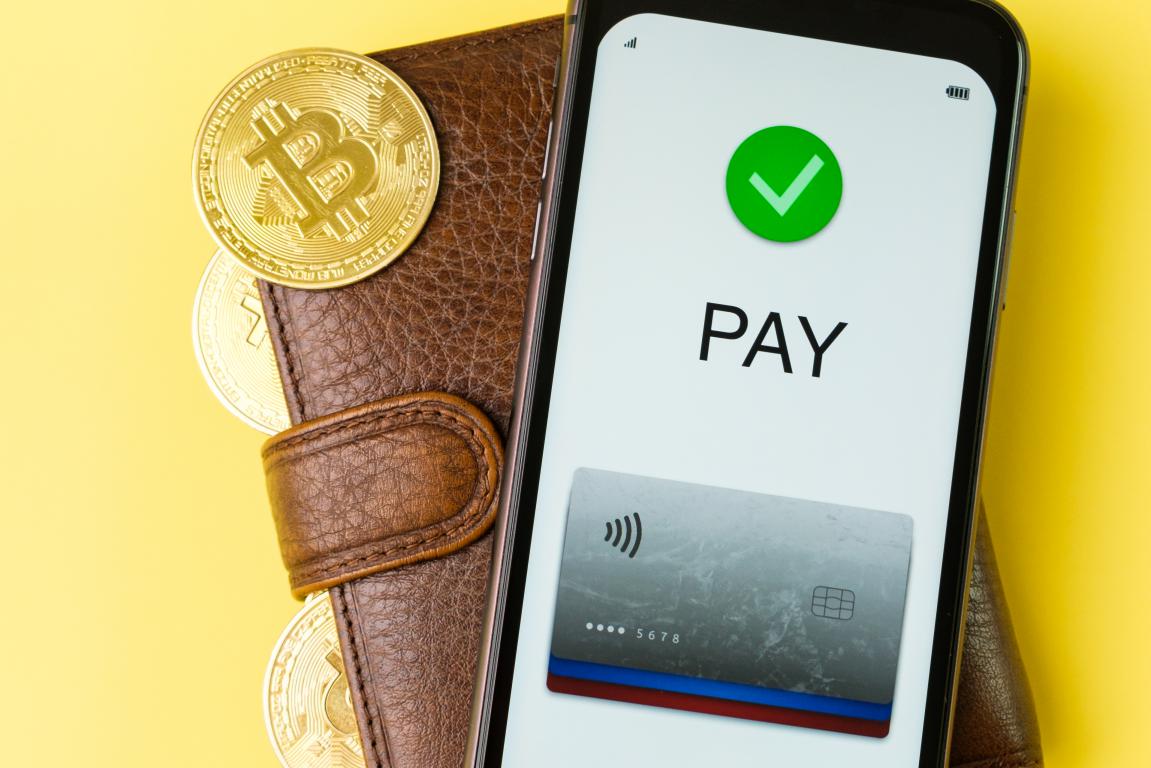  A smartphone displaying a successful mobile payment screen next to a leather wallet, illustrating the ease of digital transactions