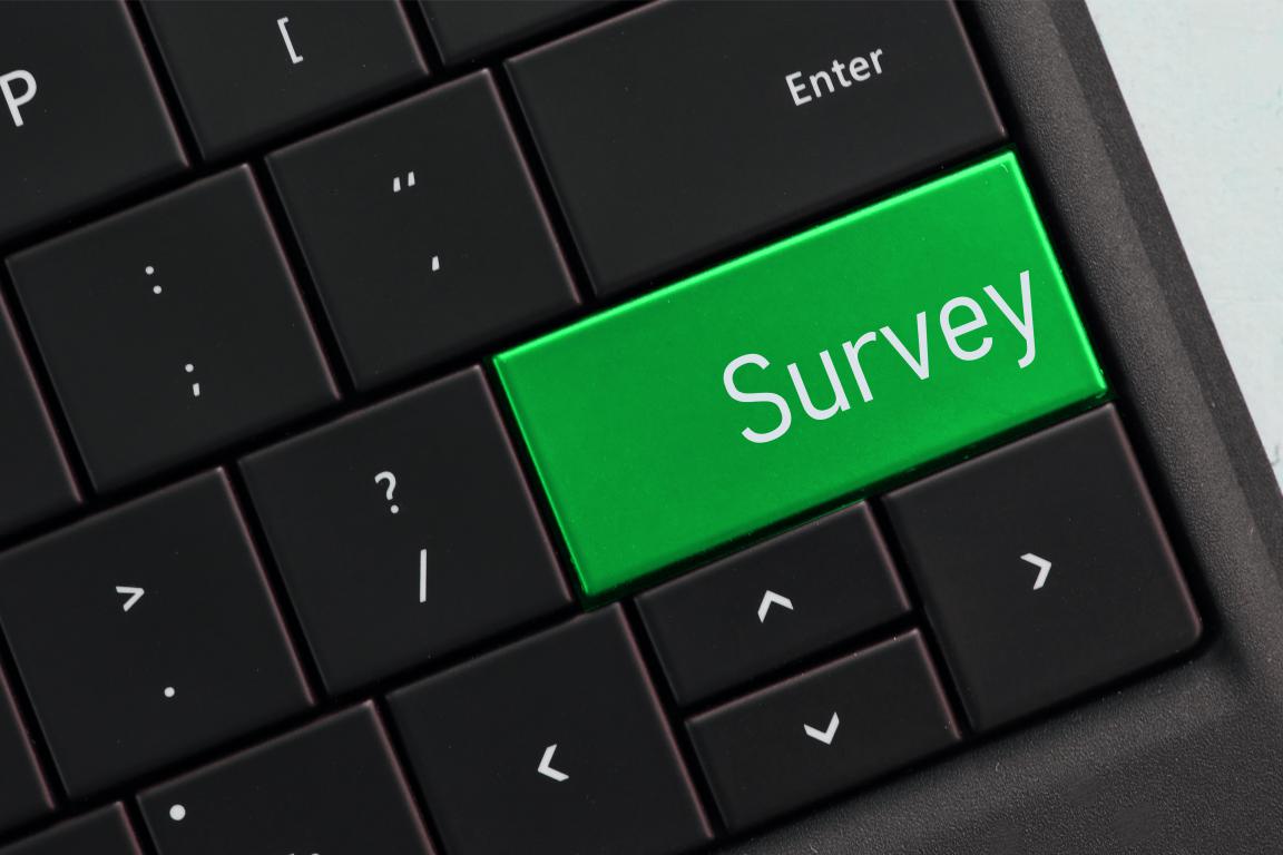 A Green Survey button on a laptop keyboard