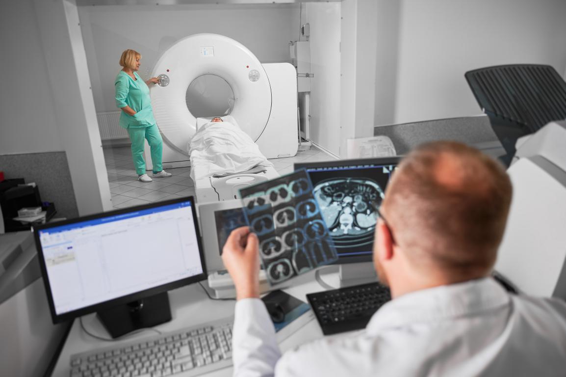 A radiologist analyzing CT scan results, a crucial alternative imaging method when an MRI is not possible due to a metal implant.