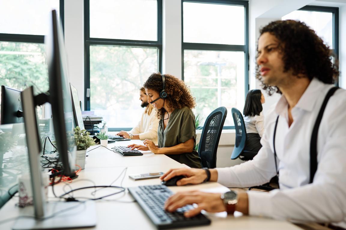 Call centre agents at work, representing a driver calling their car insurance provider to update them about their metal implant surgery.