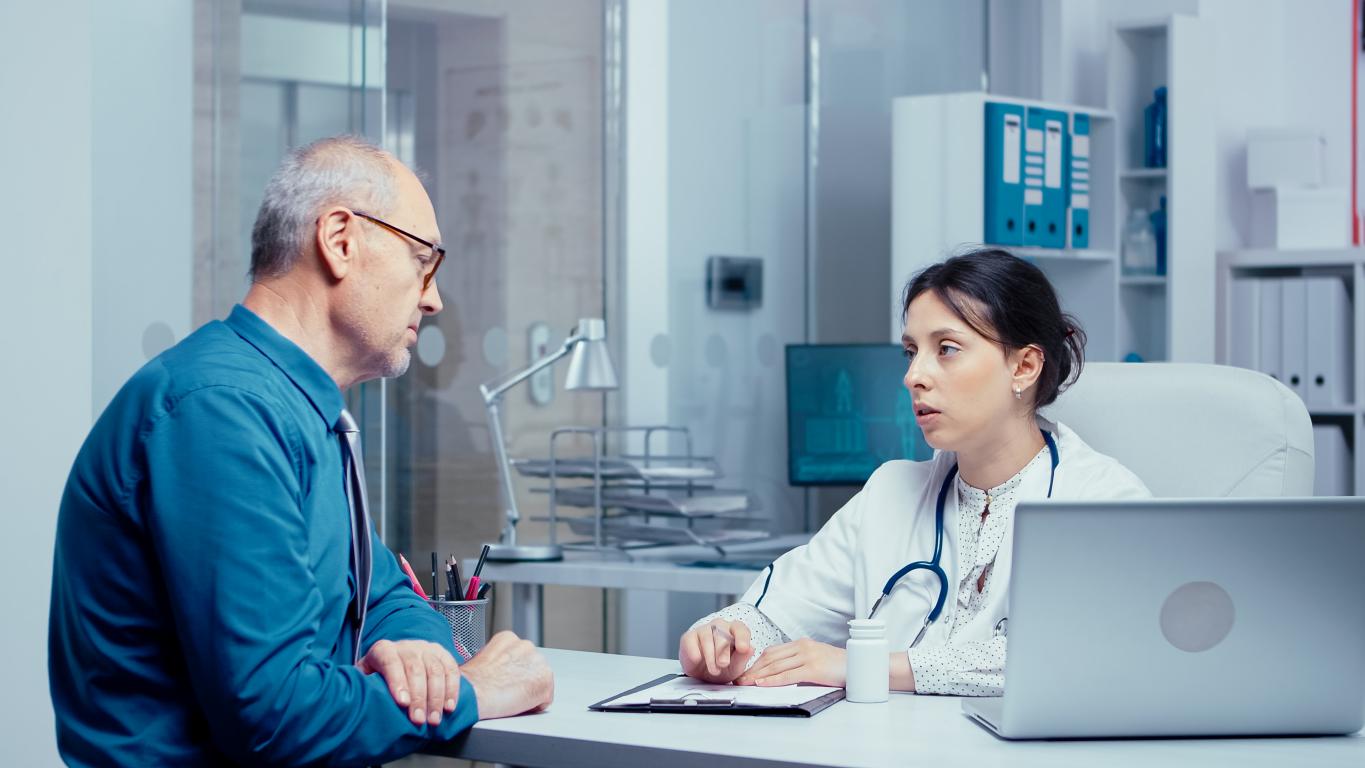 A male patient listens carefully as his female doctor explains the guidelines for being fit to drive after his medical procedure.