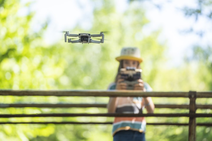 young girl practising flying a drone