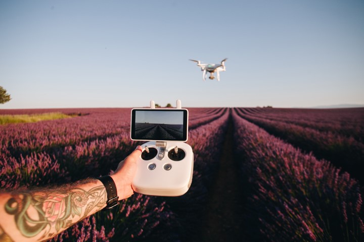 Man with tatoos flies drone
