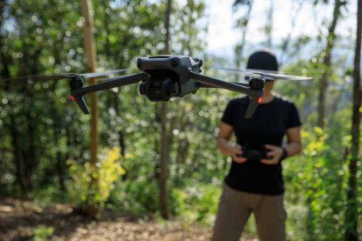 Man with drone in woods