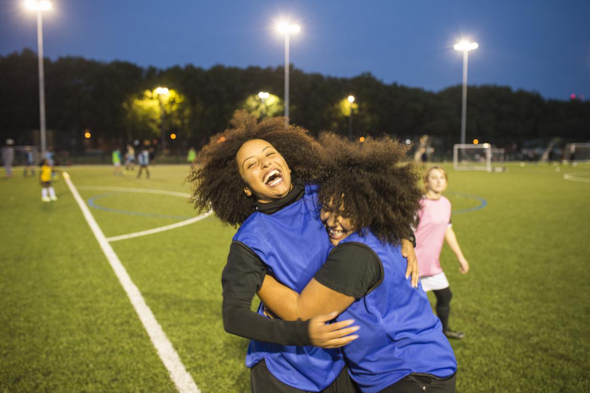 Young women celebrating after a grassroots football match