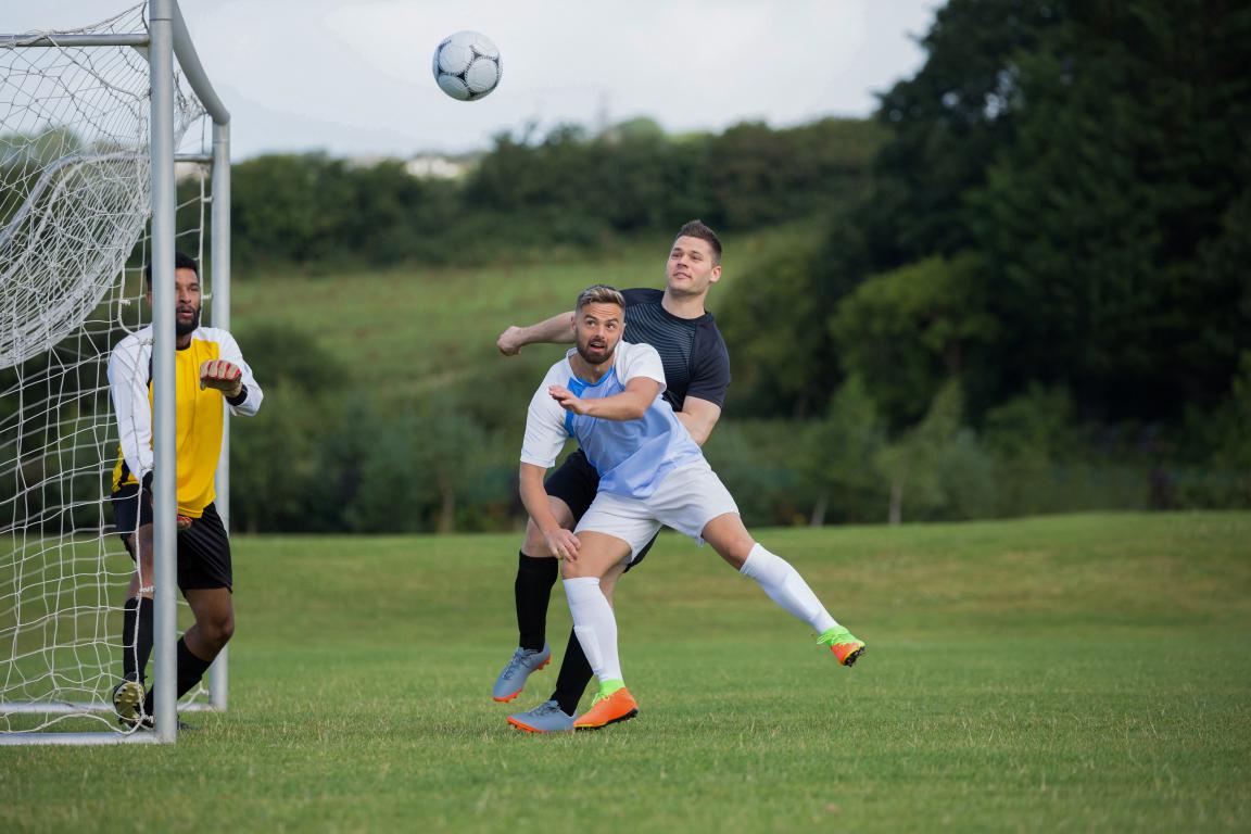 Local amateur football action on a community pitch