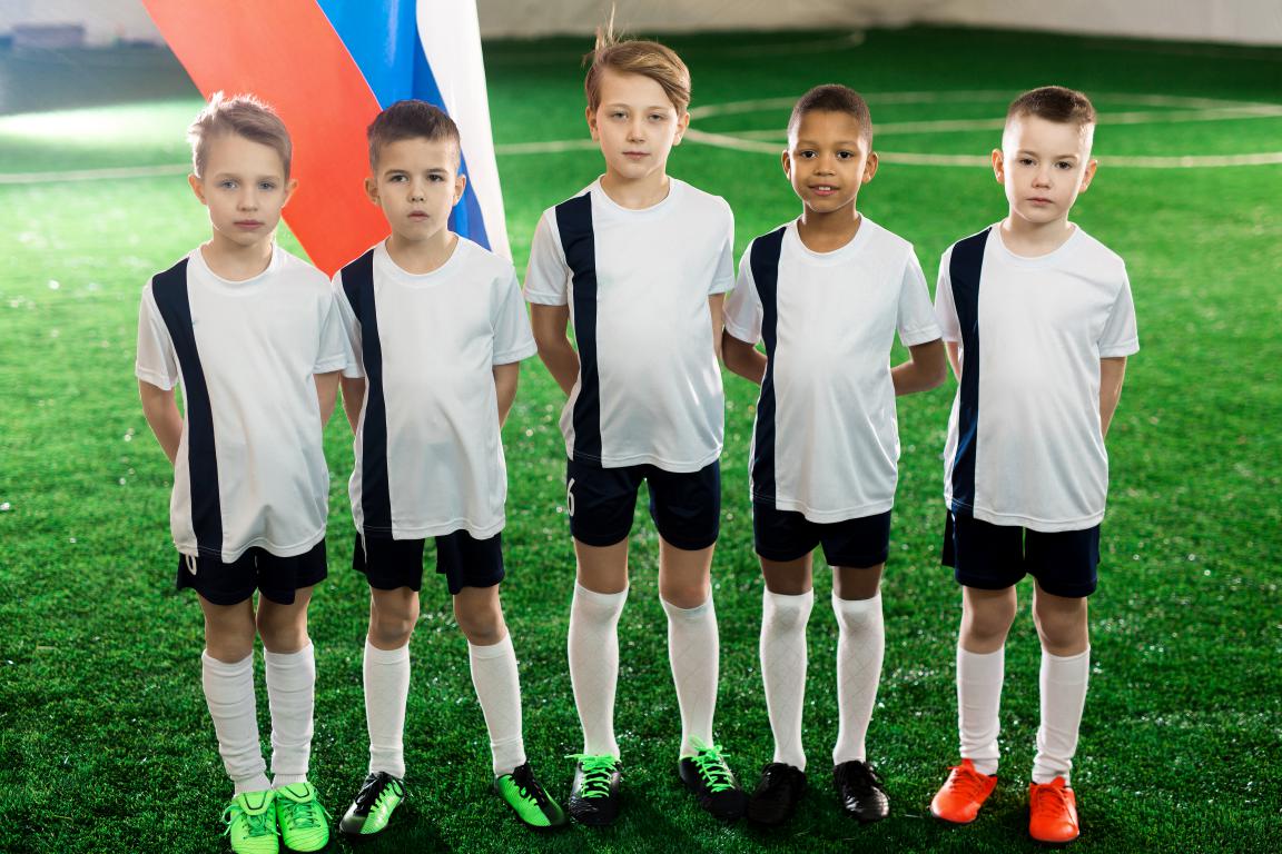 Young footballers posing as a team after a match