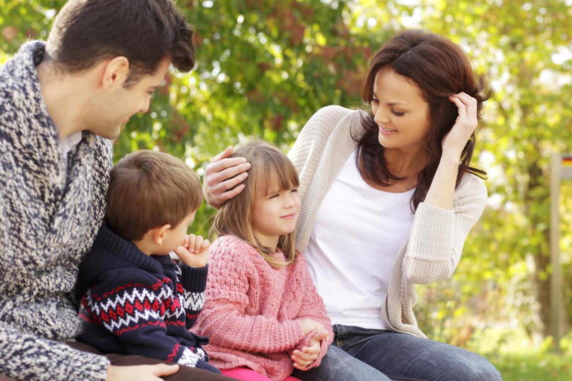 Family discussing a child's medical alert card together.